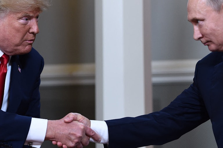Donald Trump shakes hands with Russian President Vladimir Putin