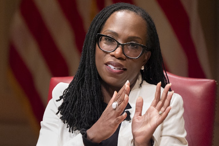 Supreme Court Justice Ketanji Brown Jackson gestures while seated onstage