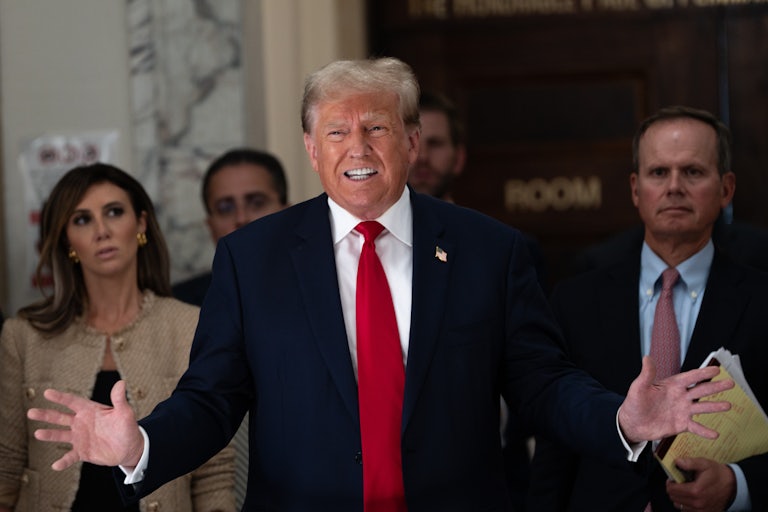 Donald Trump speaks while his legal team stands behind him