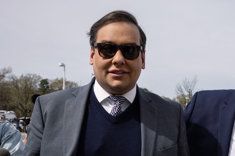George Santos walks outside a courthouse
